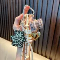 Stylish leopard bear keychain with plush bow and gold heart bag charm for women. - White