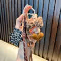 Leopard print bear keychain with Maillard style plush bow and glossy heart pendant - Coffee