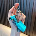Vibrant turquoise tricycle toy keychain with cargo transport truck model design. - Lake Blue