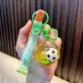 Vibrant green football liquid quicksand keychain charm with Just Keep Doing It strap - Green