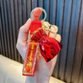 Metallic red lucky bag keychain with 'Good Lucky' strap for car keys or bag charm decoration - Red