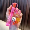 Pink liquid glitter football keychain with Just Keep Doing It motivational strap - Red