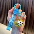 Blue liquid soccer ball keychain with 'JUST KEEP DOING IT' silicone strap and glitter - Blue