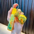 Luxury golden lucky bag keychain with yellow woven strap and Good Luck charm detail - Yellow