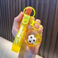 Yellow soccer ball quicksand keychain with "JUST KEEP DOING IT!!" strap - Yellow