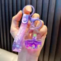 Purple liquid glitter fruit popsicle keychain featuring grape charms and strap - Purple