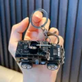 Detailed black armored police car model keychain featuring pull-back action and metal ring - Cannon