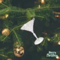 Elegant transparent acrylic martini glass ornament hanging on a festive Christmas tree - Wine Glass Style / Clear