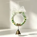 Close-up of DIY Christmas wreath made of green and white chenille stems with a bronze bell - Style 2 / Diameter approx 9.5cm