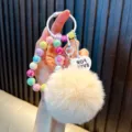 Cute colorful beaded keychain with a large fluffy beige pom-pom and heart-shaped pendant detail - Beige (Random Beads Tag)