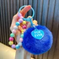 Vibrant blue plush pom pom keychain featuring colorful iridescent beads and heart charm - Royal Blue (Random Beads Tag)