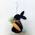 Black felt Easter bunny ornament featuring a glittery orange carrot and white ribbon - Black