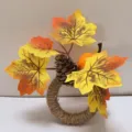 Detailed view of handmade twine napkin ring with artificial maple leaves and pinecone - Pumpkin Maple Leaf Pine Cone Style (Style 2) / 5x8.5x10cm