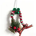 Detail view of a handmade Christmas pipe cleaner bell ornament with pearls - Artificial Pearl Accents With Golden Reindeer Style