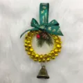 Close-up detail of a festive Christmas bell wreath featuring a green Happy Christmas ribbon bow - Diameter approx 12cm / Yellow
