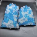 Two packs of reusable blue and white plastic ice cubes stored in black mesh bags - 200 Pieces (24x24cm)