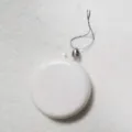 Close-up macro view of a plain white flat circular Christmas ornament with silver hanging string - Set of 24 / Silver