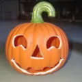 Detailed view of a classic orange plastic Halloween Jack-o'-lantern lamp ornament - Happy Pumpkin Regular Style