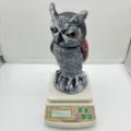 Realistic owl decoy bird scarecrow on a scale showing 308.8 grams weight - Shaking Head Long Ear / Bag Packaging