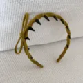 Detailed view of a stylish mustard yellow flocked bow headband featuring anti-slip teeth design - Bow Headband / Yellow