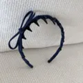 Detailed view of a blue velvet headband with a decorative side bow and anti-slip teeth - Bow Headband / Dark Blue