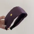 Detail view of American vintage purple wide headband with gold Smile Happy metal tag - Wide Gold Logo (FG89290) / Purple