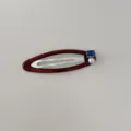 Vue détaillée de l'élégante décoration en perles et zircon bleu sur la barrette rouge - Clips BB / Bordeaux