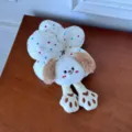 Close-up of cute plush puppy flower hair scrunchie with colorful polka dots fabric - Beige Dog Scrunchie