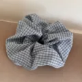 Detailed view of large blue checkered fabric scrunchie with soft textile pleats. - 8# Light Gray Plaid