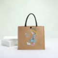 Eco-friendly natural burlap tote bag with a cute girl and cat print illustration - Straw Hat Girl
