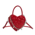 Red heart shaped crossbody bag with quilted hearts, top handle and silver chain strap. - Red Embossed Heart Mini Bag