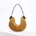 Macro detail of mustard yellow crescent hobo bag decorated with turquoise and gold studs - Brown