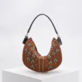 Brown crescent hobo bag decorated with turquoise stones and gold studs on white podium - Coffee
