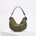 Detailed view of an olive green crescent bag with turquoise and gold rivet studs - Green