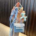 Llavero mini bolso de cuero PU azul claro con dije de perro globo iridiscente y cuerda - Azul