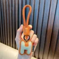 Premium orange leather letter H keychain charm with woven rope for bags and car keys - Letter H