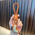 Premium orange PU leather alphabet keychain featuring a padded letter L design bag charm - L