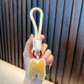 Stylish yellow and white PU leather letter M alphabet keychain with durable hand strap - M