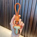 Handcrafted orange brown leather keychain pendant with a stylish letter T design - Letter T
