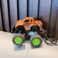 Miniature orange off-road monster truck keychain with green wheels and suspension - Orange
