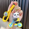 Cute cartoon PVC panda riding a bicycle keychain charm with yellow spiral wrist strap - Yellow