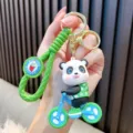 Adorable cartoon panda riding bicycle PVC keychain with green woven wrist strap and charm - Green