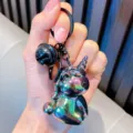 Vibrant electroplated acrylic unicorn keychain pendant with a large black bell attachment - Black