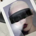 Close-up of futuristic oversized black wrap-around sunglasses in cyberpunk style. - Black