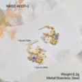 Detailed macro shot of gold stainless steel hoop earrings with daisy and clover charms - Four-Leaf Clover and Daisy Beaded Earrings (NMSE-M337-3) / 18K Gold / Gold