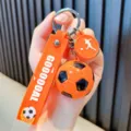 Vibrant orange football keychain featuring a silicone strap with GOOOOOAL text and charm - Orange