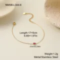 Detailed macro view of gold stainless steel birthstone bracelet with red zircon charm - Teardrop Pink Zirconia Bracelet (NMSB-L344-6)