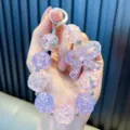 Irisierende rosa und violette Perlen-Handgelenkschlaufe mit einem dekorativen Bogen - Rosa