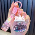 Adorable pink Maneki-neko lucky cat liquid quicksand keychain with flower sequins - Pink