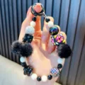 Dragonne de téléphone perlée faite main avec pompons noirs et perles décoratives colorées - Noir avec Pompon